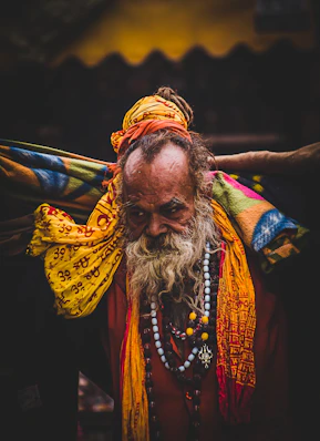 A man with a long beard wearing a yellow scarf