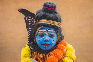 A young child dressed in a costume and holding a sword