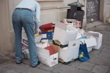 A man standing next to a pile of boxes