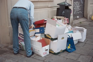 A man standing next to a pile of boxes