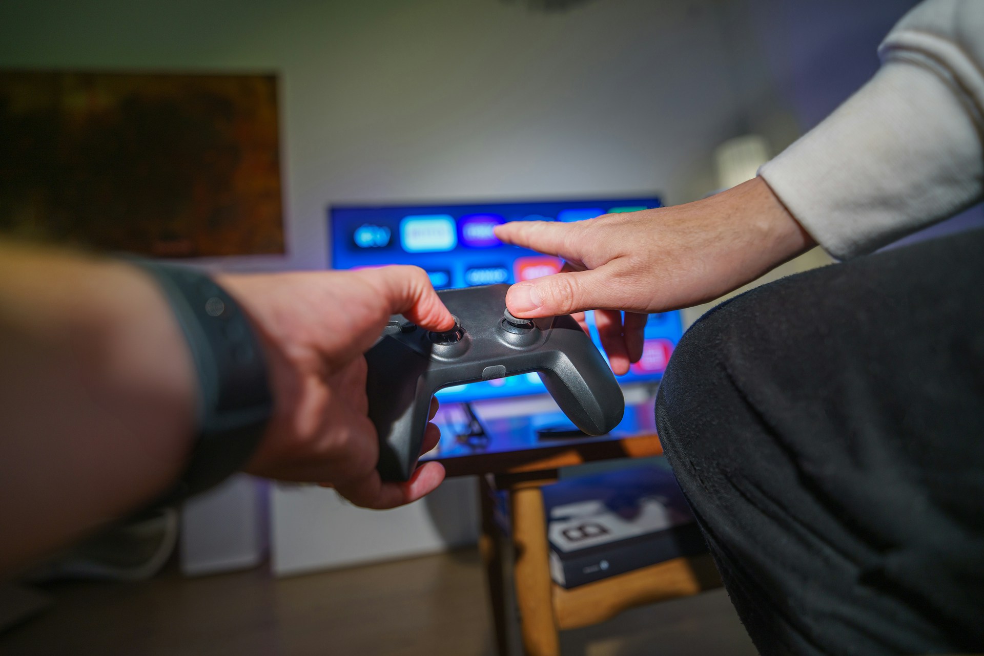 A person holding a video game controller in their hand