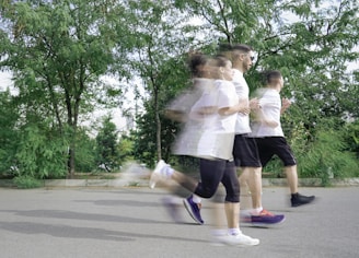 A group of people running down a street