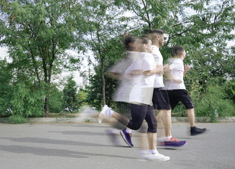 A group of people running down a street