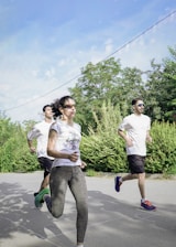 A group of people running down a street