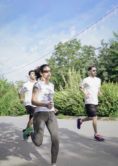 A group of people running down a street