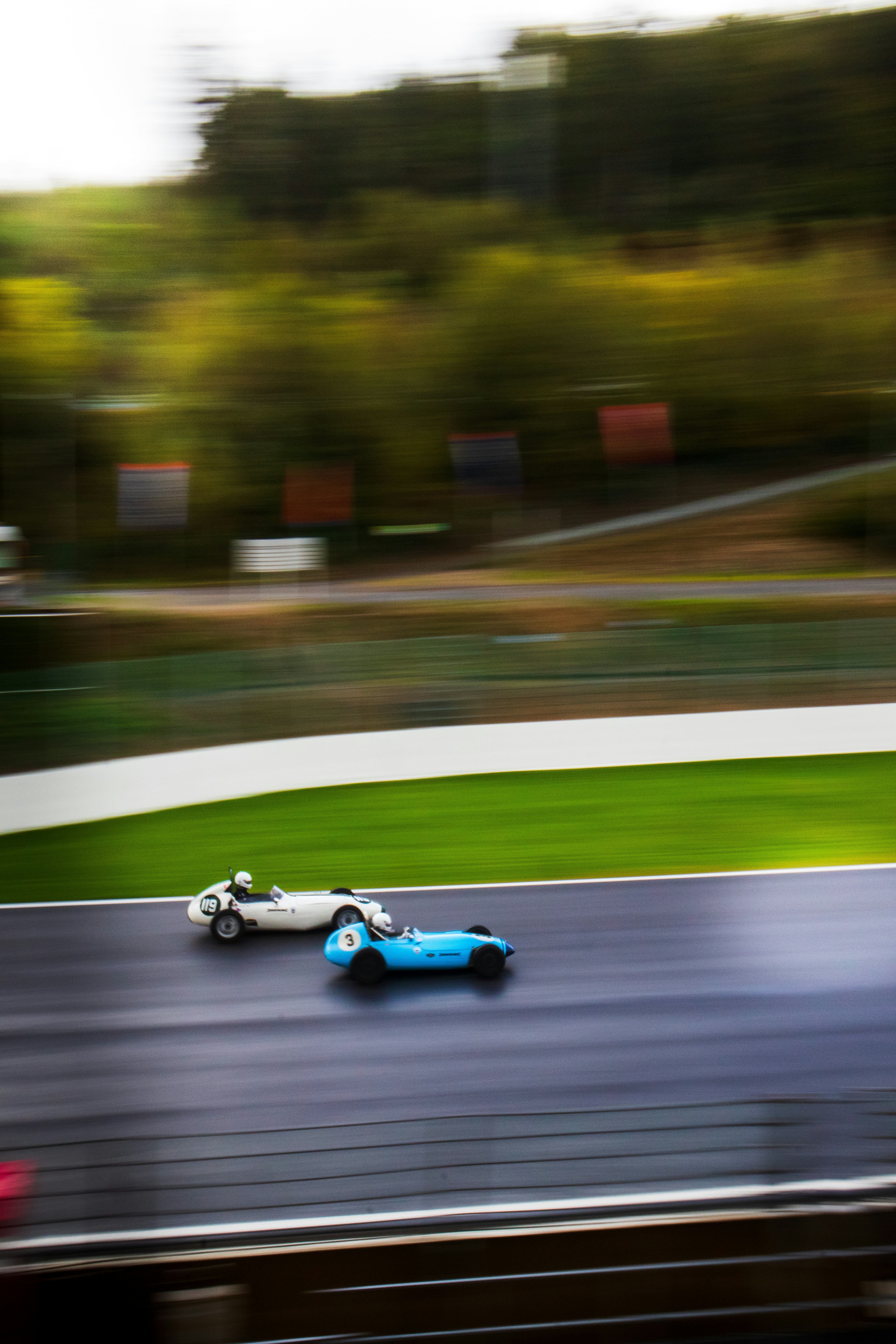 A blurry photo of two racing cars on a track