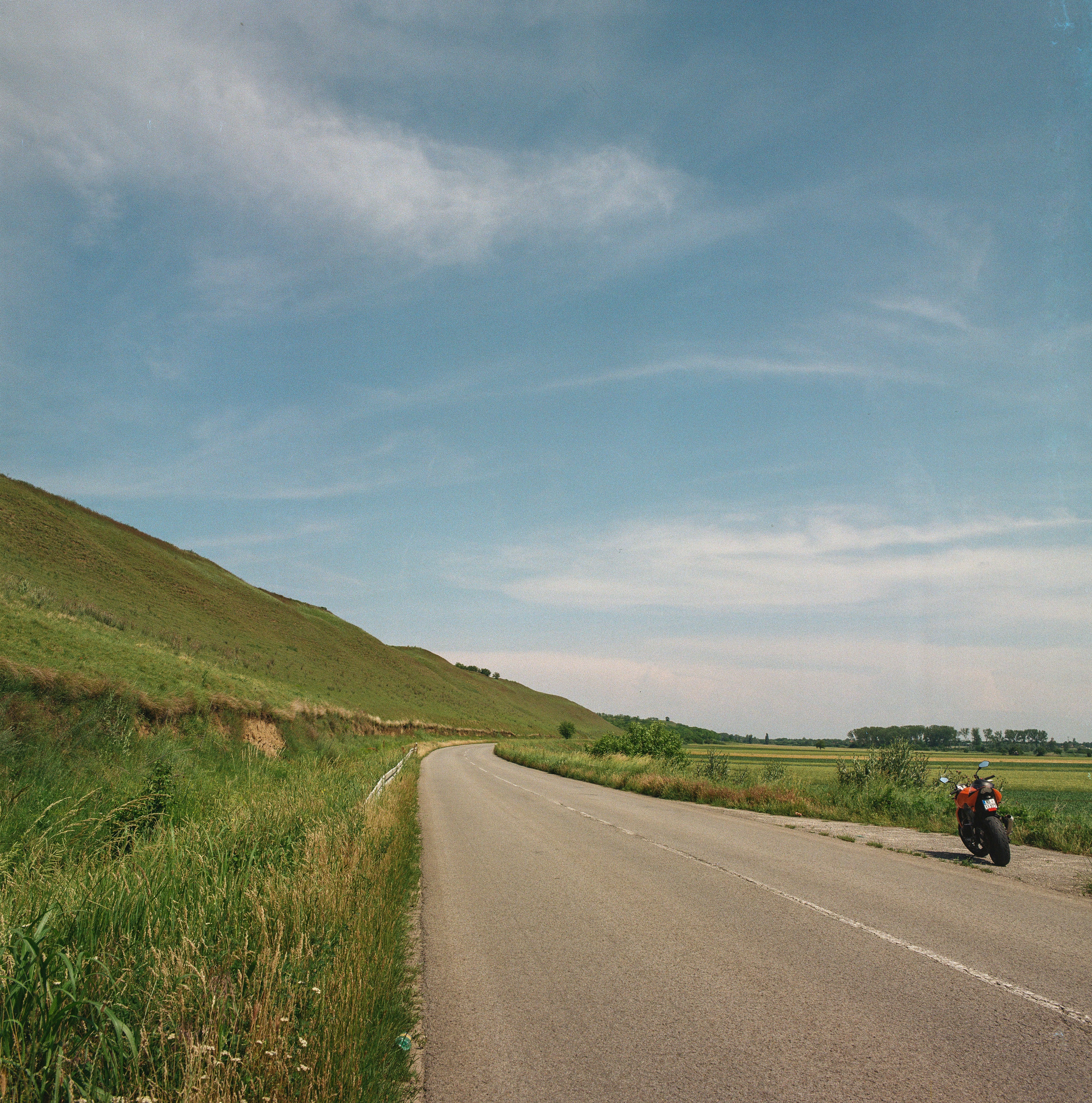A person riding a motorcycle down a curvy road