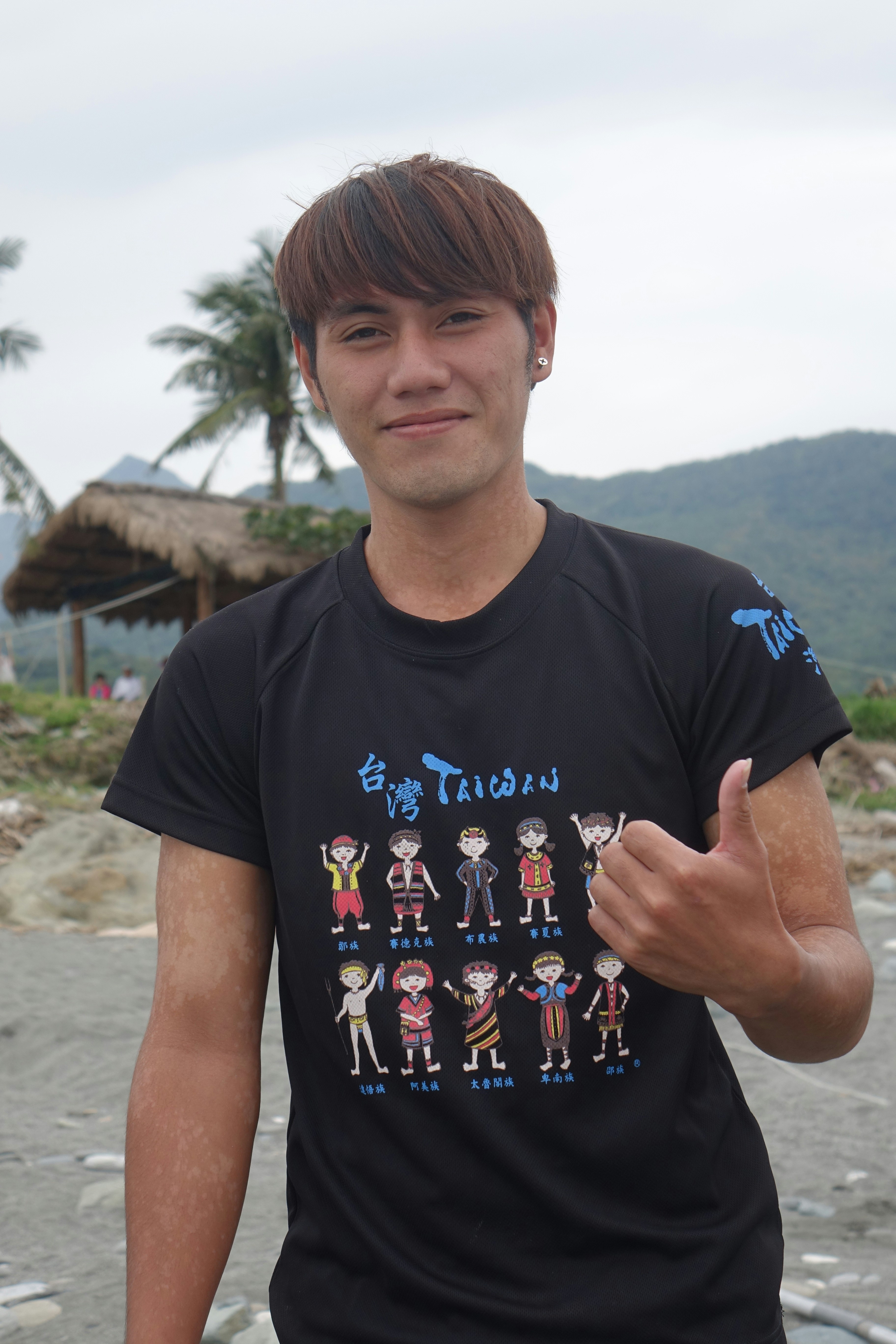 A young man giving the thumbs up sign