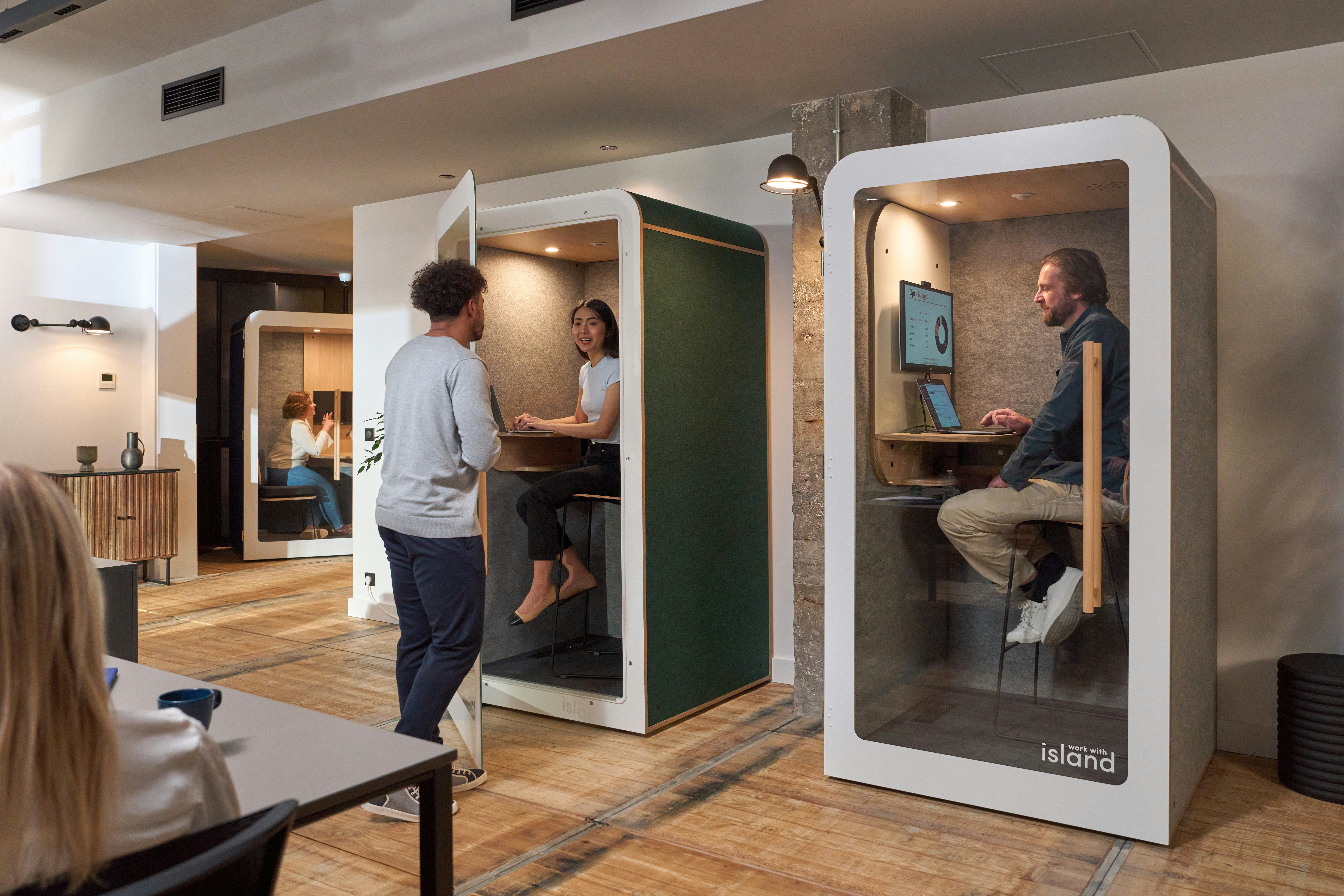 A group of people standing around a room