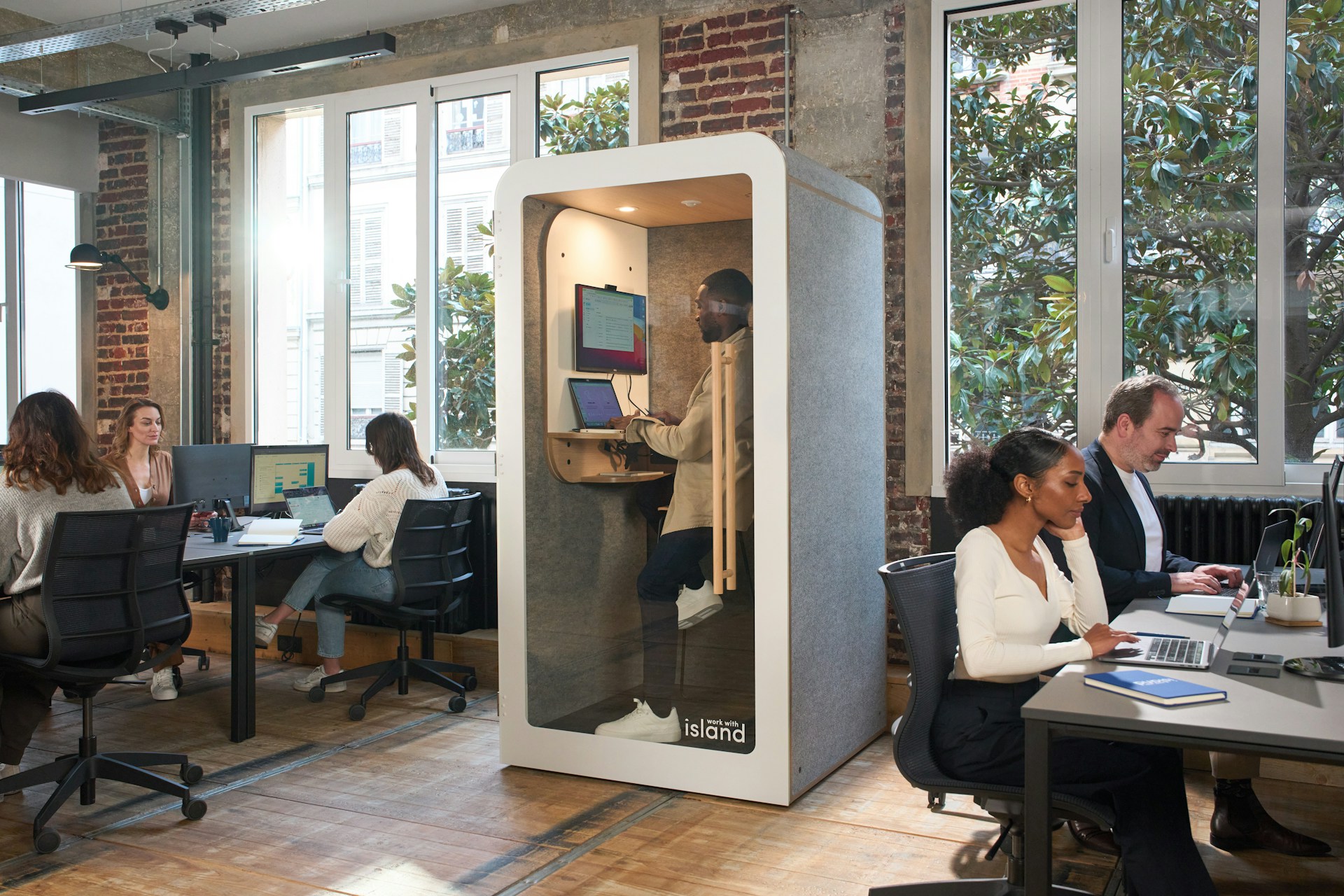 A group of people sitting at desks in an office