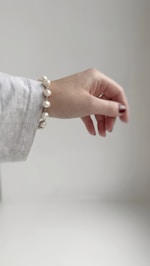 A woman's hand with a pearl bracelet