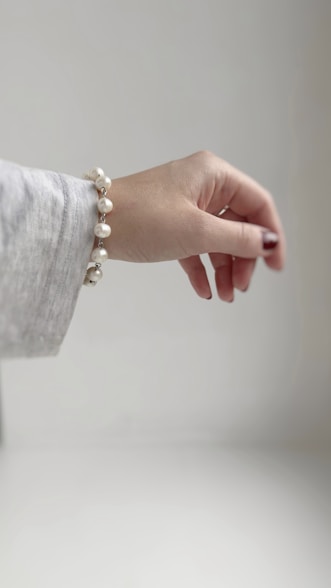 A woman's hand with a pearl bracelet
