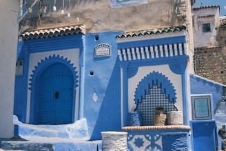 The Literary Titans of Tangier A blue and white building with steps leading up to it