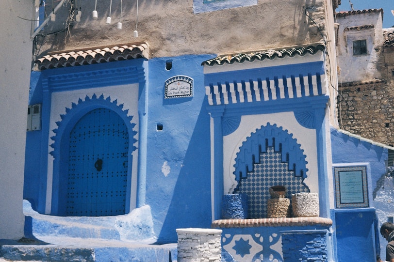 The Literary Titans of Tangier A blue and white building with steps leading up to it