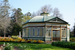 A gazebo in the middle of a flower garden