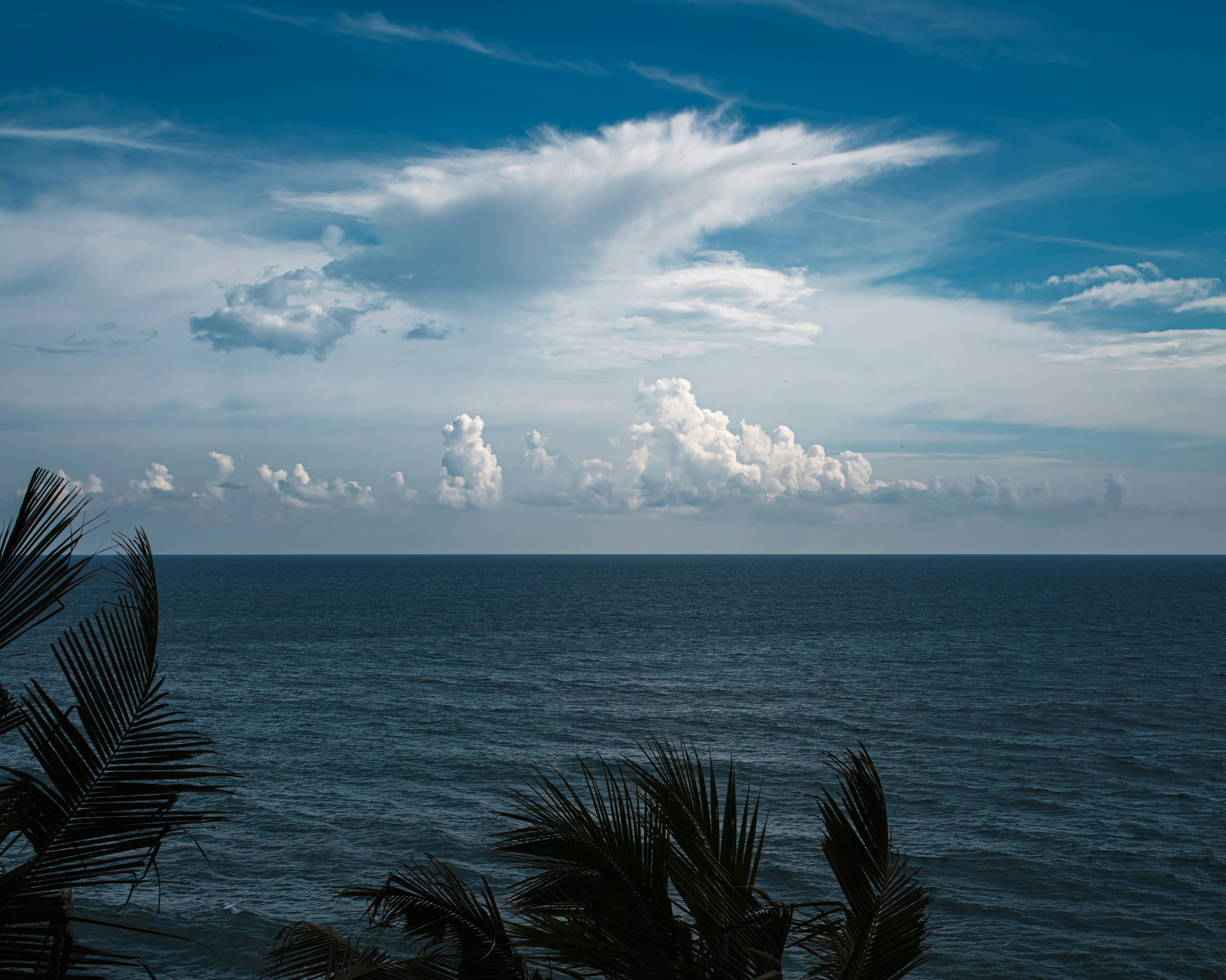 A view of a body of water with clouds in the sky photo – Free Varkala ...