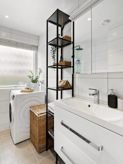 A bathroom with a washer and dryer in it