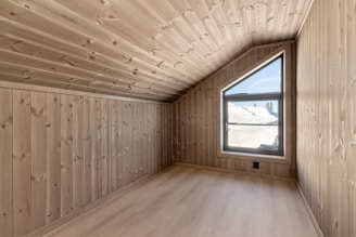A room with wooden walls and a window