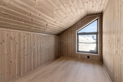 A room with wooden walls and a window