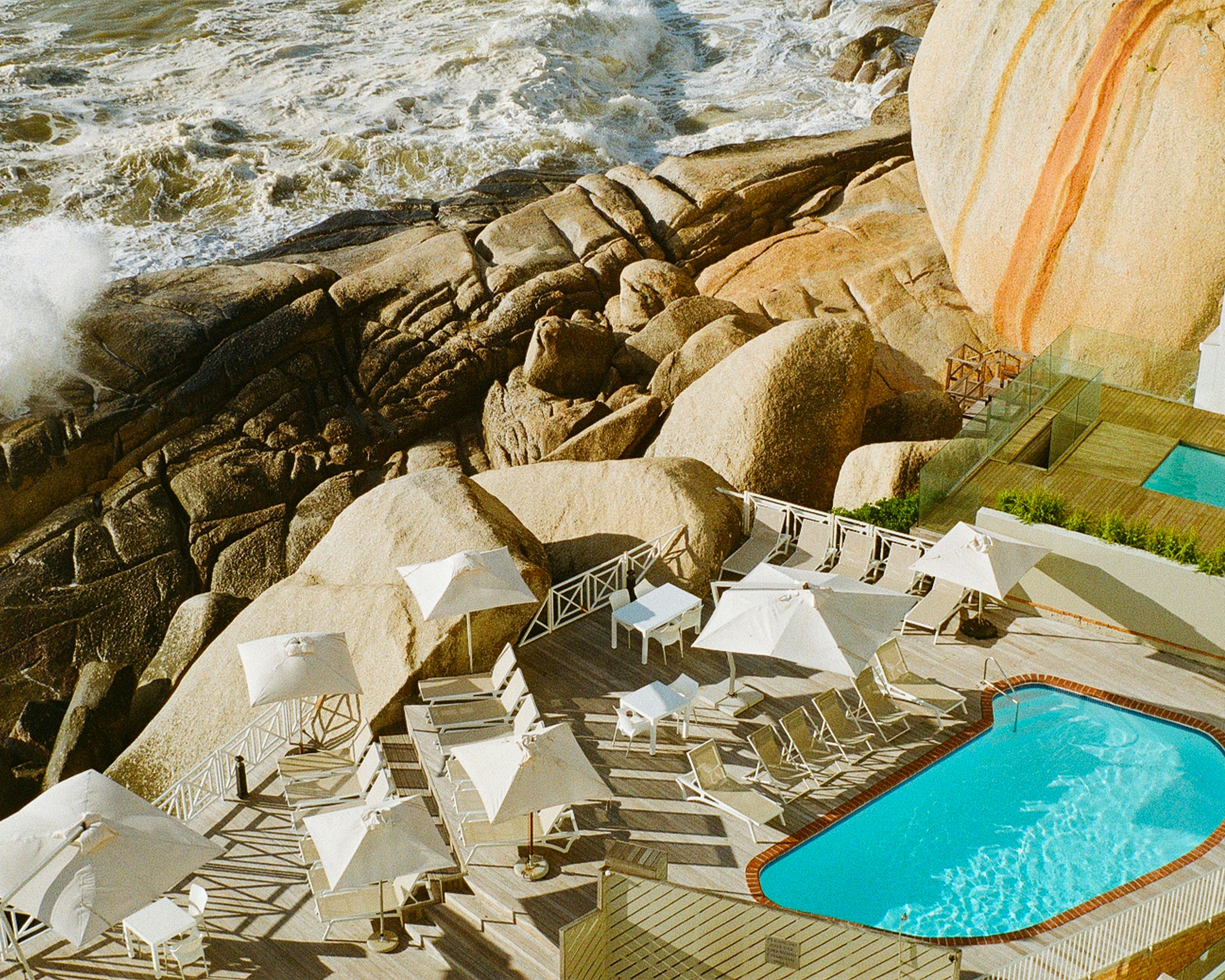 An aerial view of a resort with a swimming pool