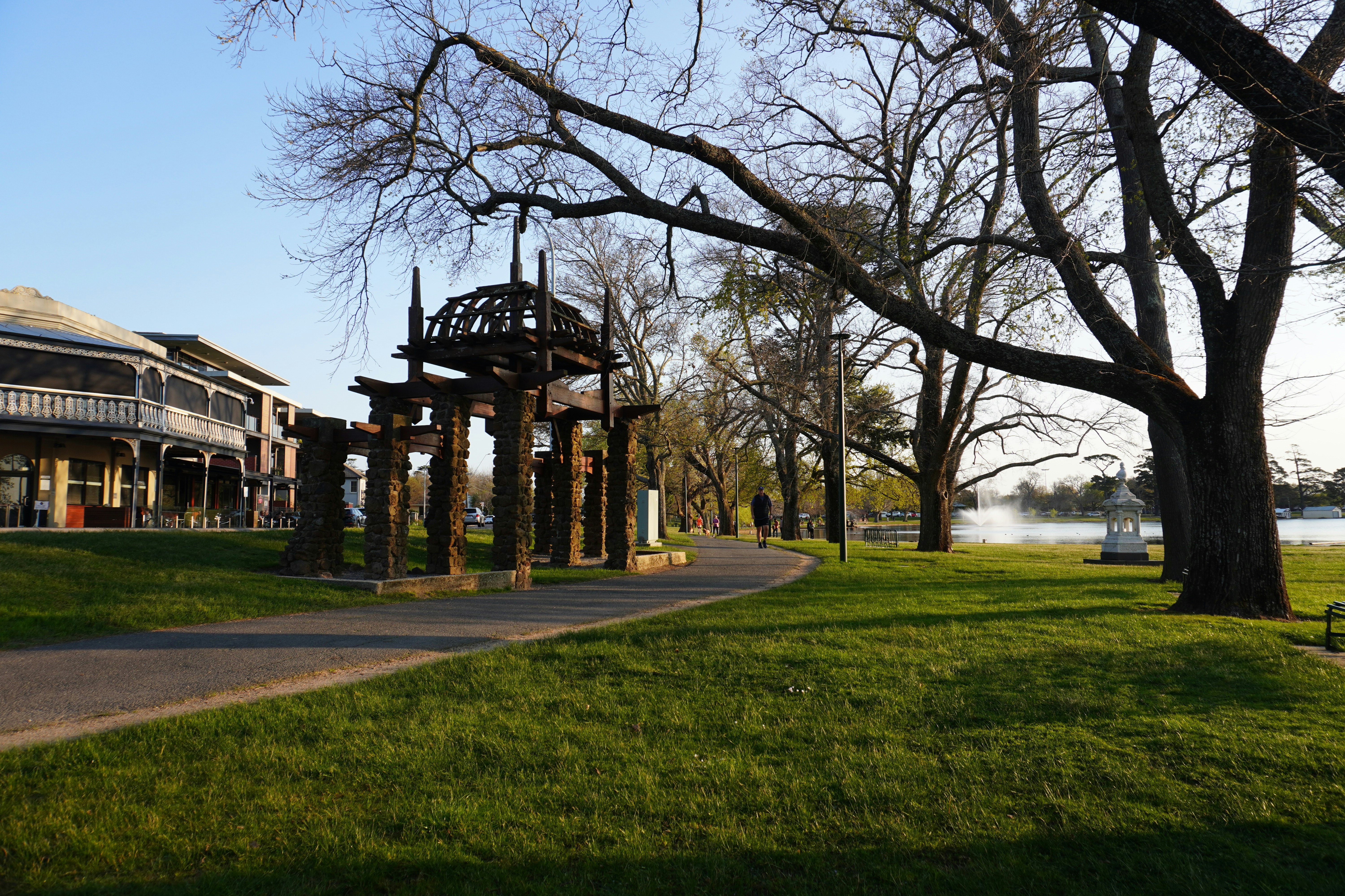 A view of a park with a gazebo in the foreground