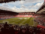 A stadium filled with lots of people watching a soccer game