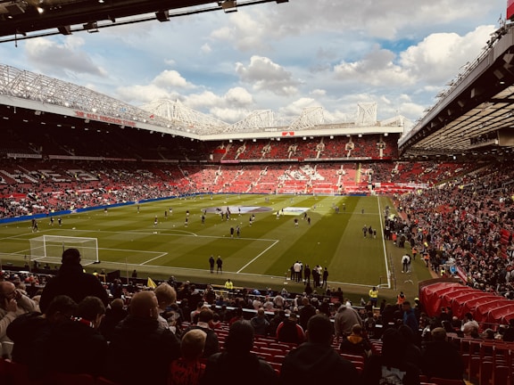 A stadium filled with lots of people watching a soccer game