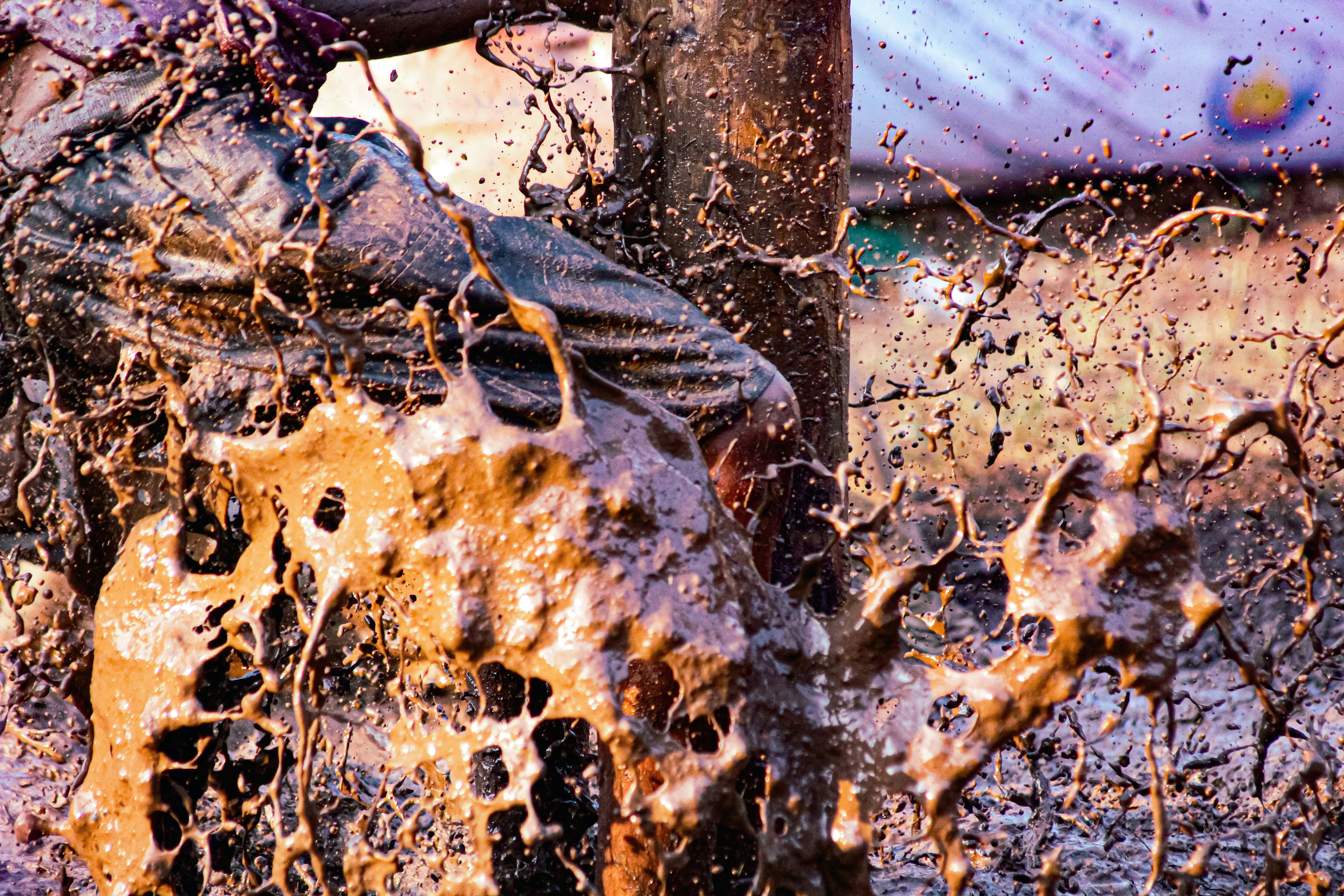 A man riding a dirt bike through a mud puddle