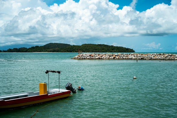 A small boat floating on top of a large body of water — Langkawi, Malaysia