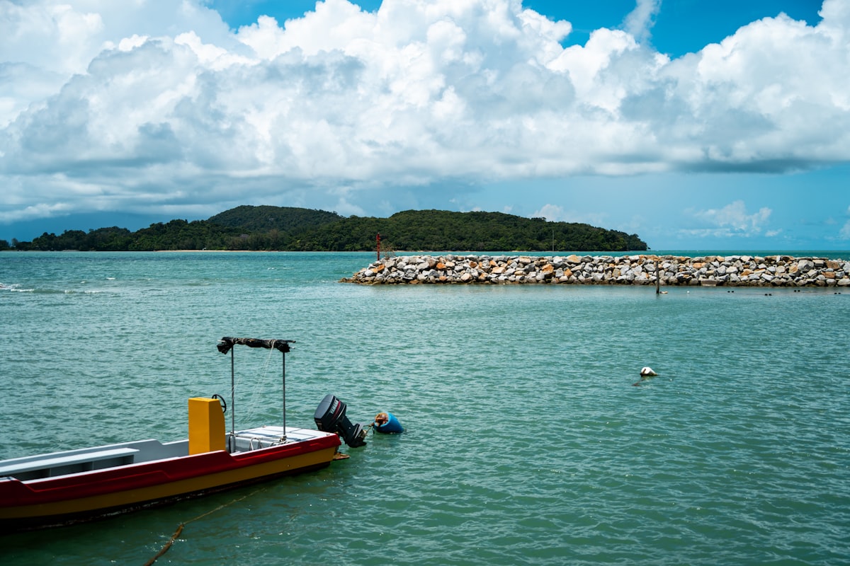 Langkawi July — luxury resort pool with rainforest backdrop