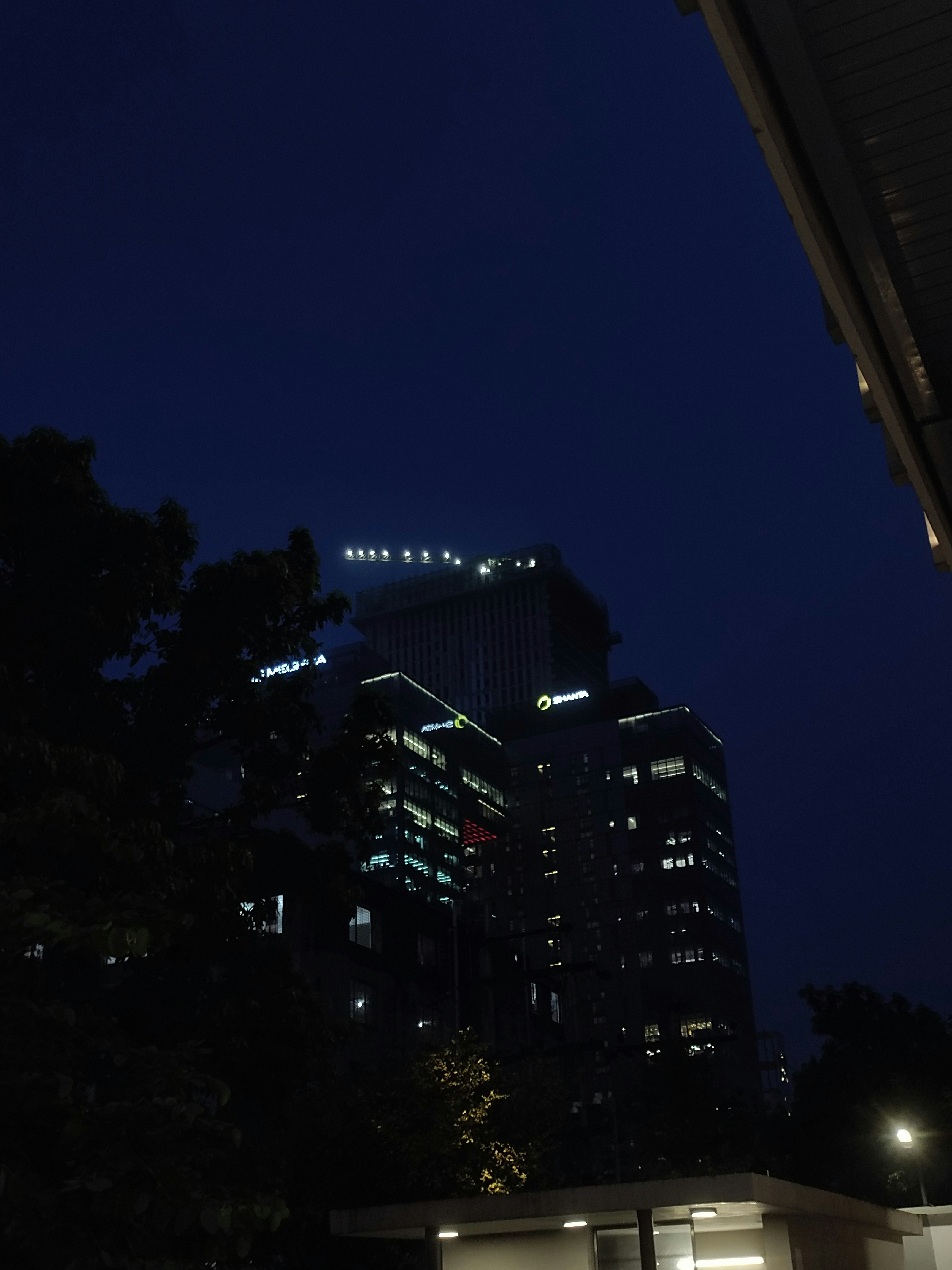 Modern real estate office at night with deep blue ambient lighting and city skyline