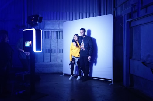 A man and a woman standing in front of a wall