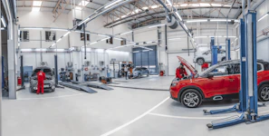 A red car is parked in a garage