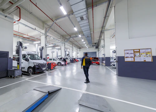 A man is walking through a large garage