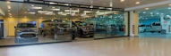A car showroom with a lot of cars in it