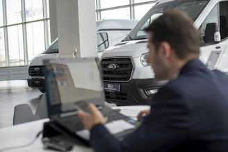 A man sitting in front of a laptop computer