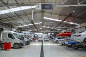 A warehouse filled with lots of cars and trucks