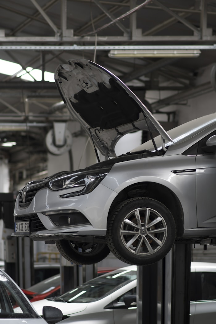 A car being worked on in a detailing and repair shop