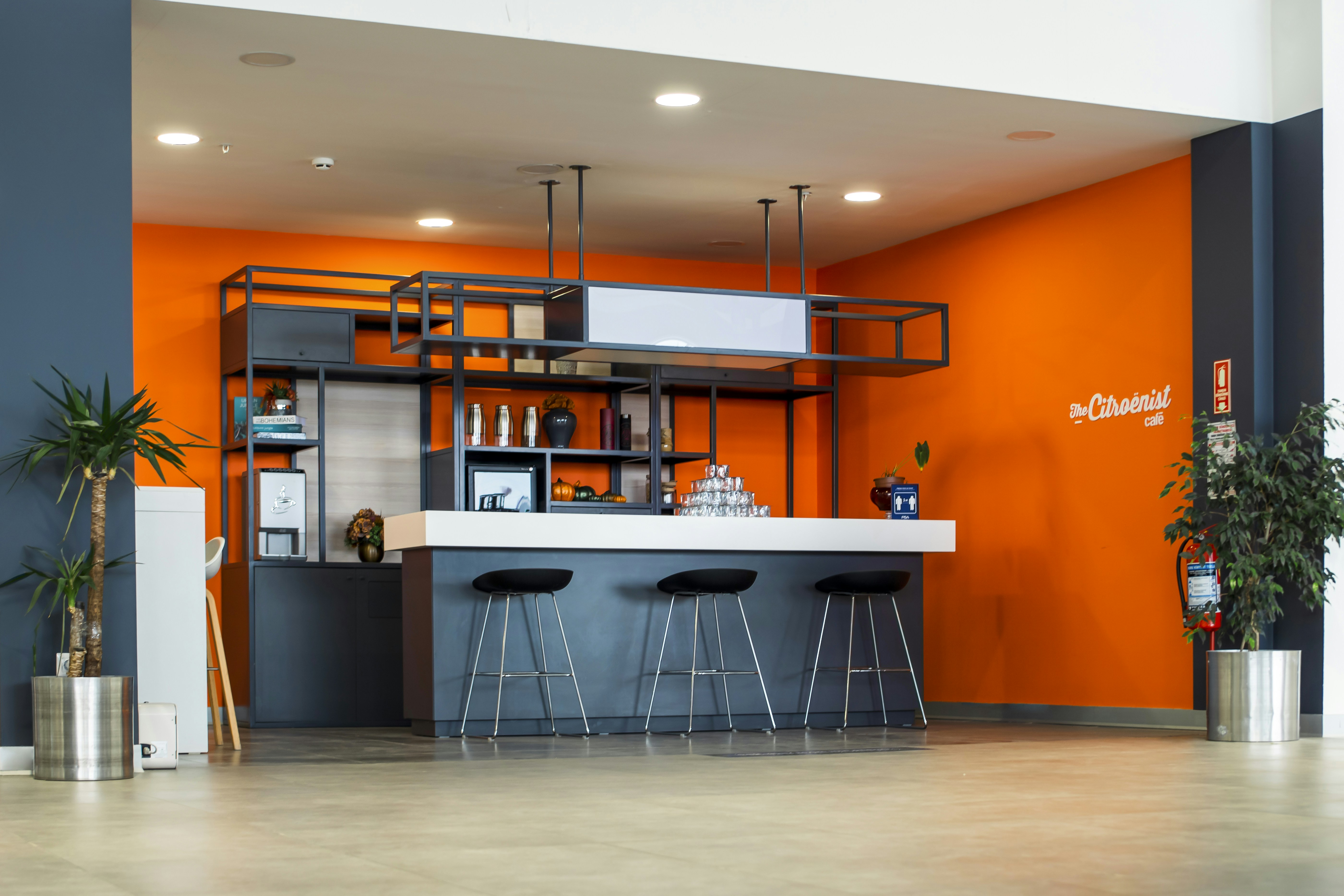 An orange and blue room with bar stools