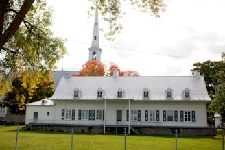 A large white church with a steeple on top of it
