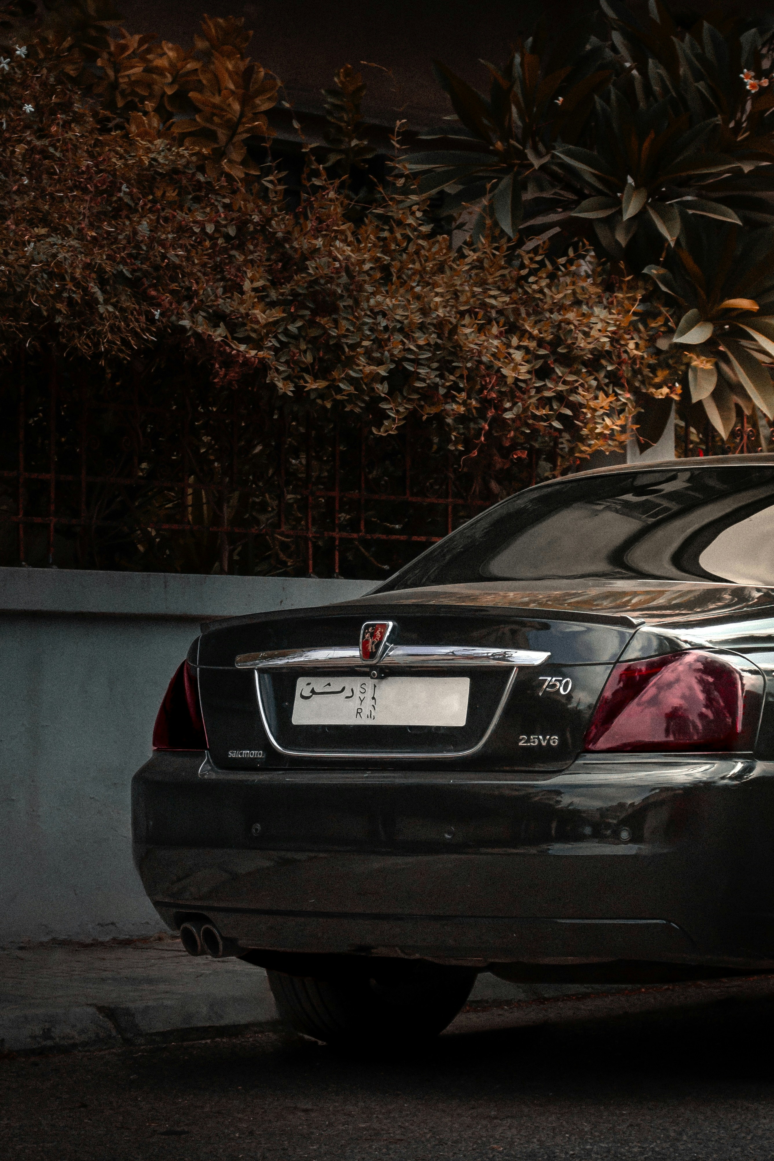 A black car parked on the side of the road