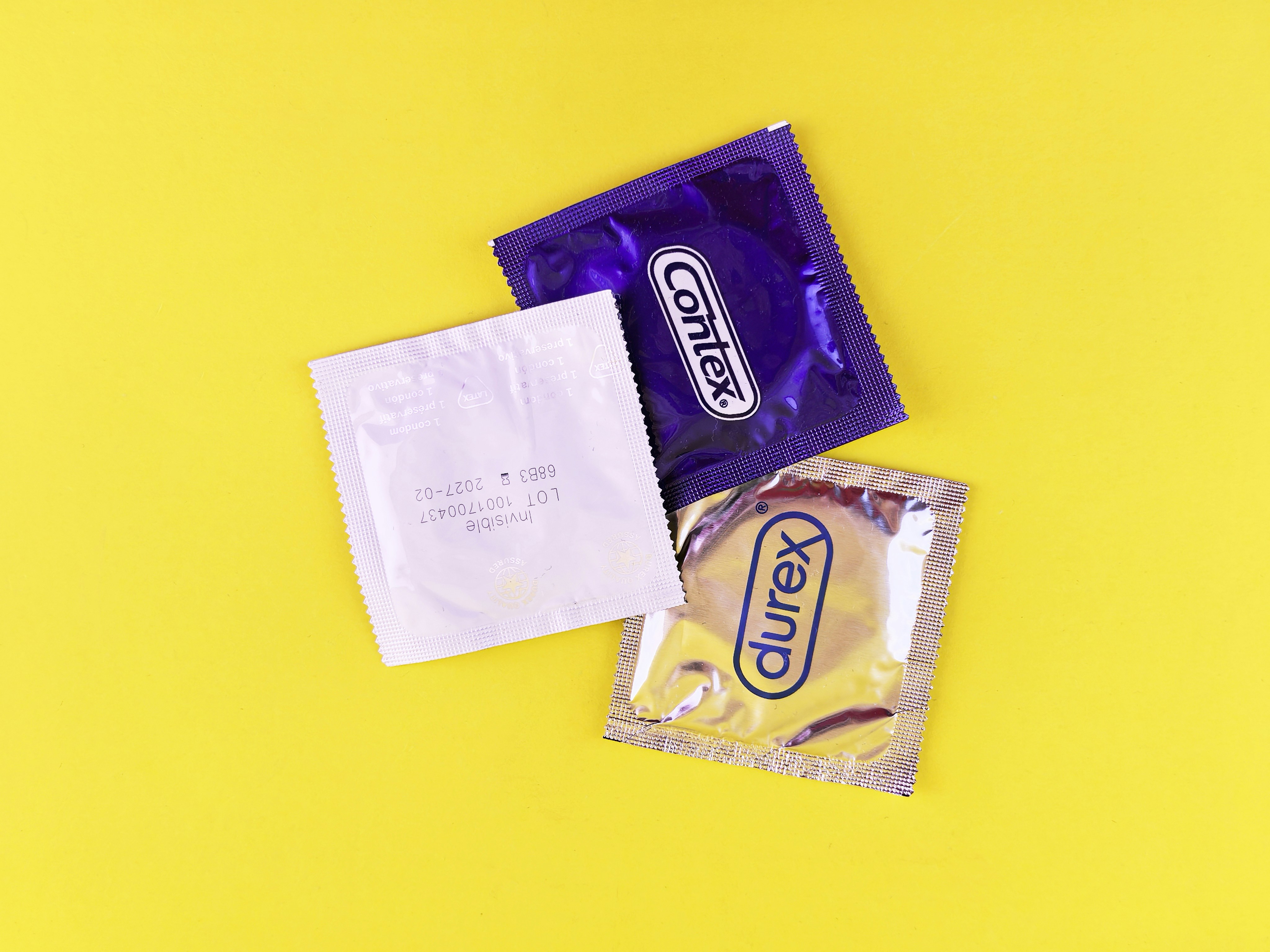 A couple of bags of candy sitting on top of a yellow table
