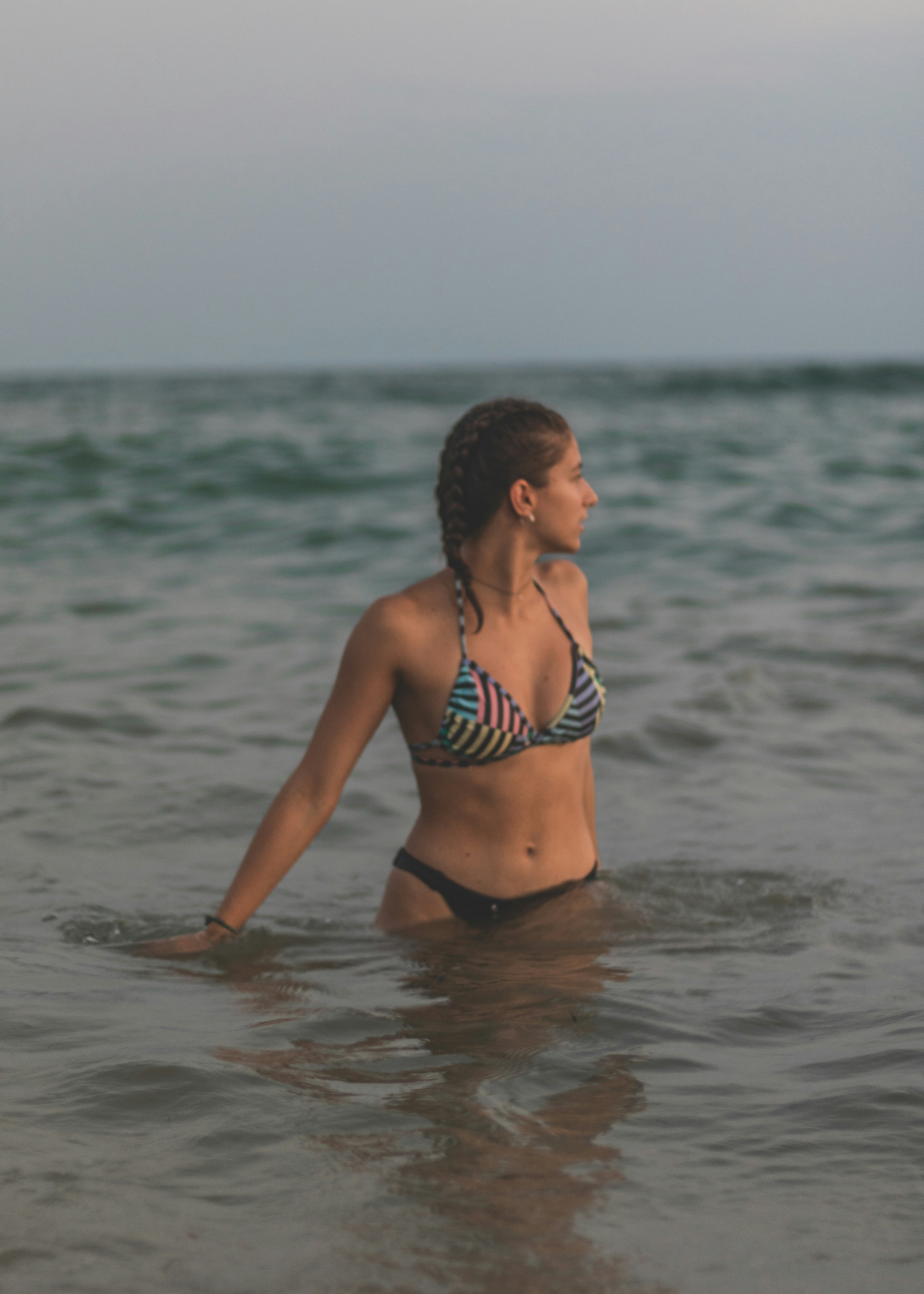 A woman in a bikini standing in the ocean