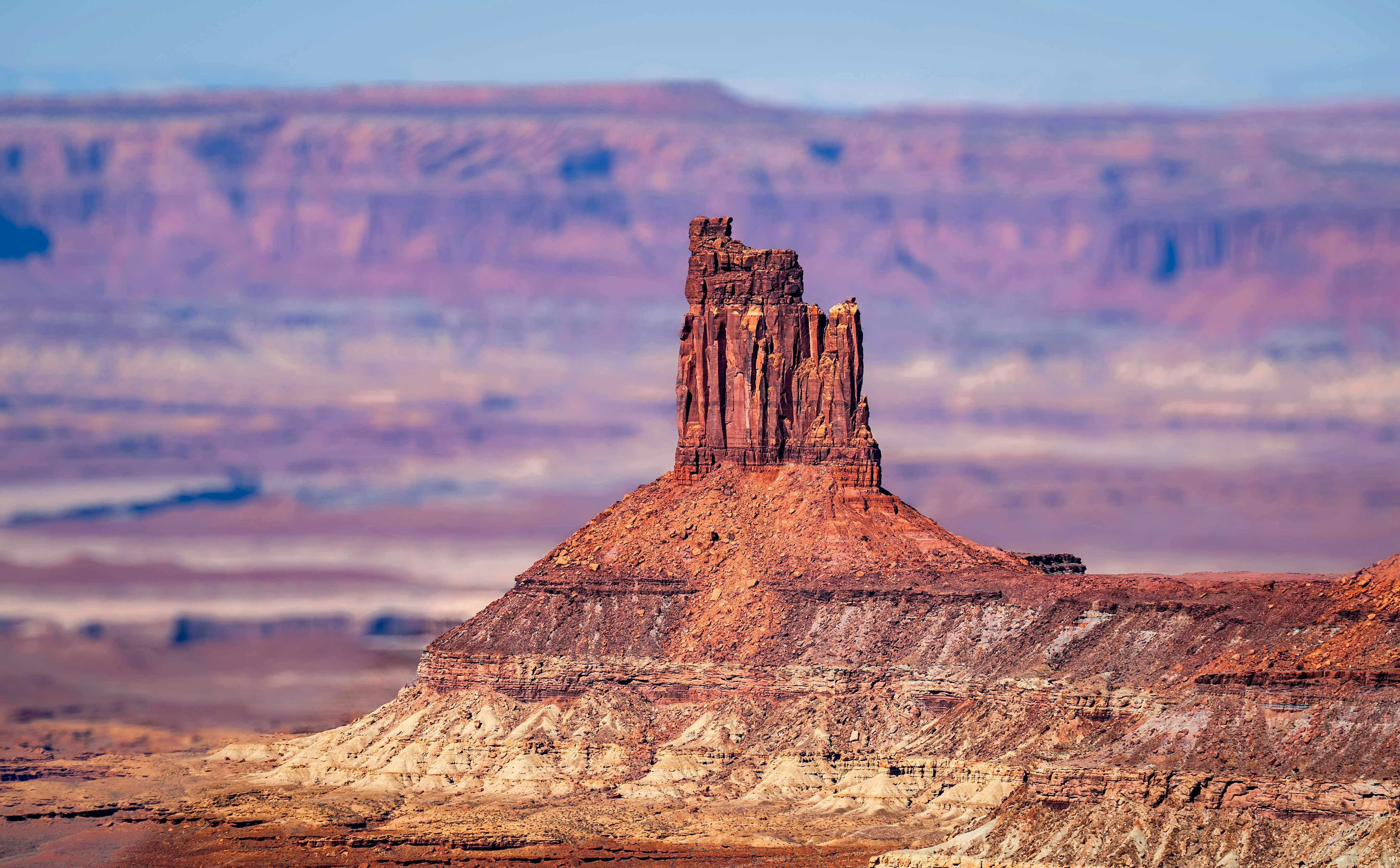 A large rock formation in the middle of a desert