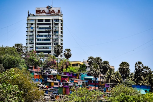 A tall building sitting on top of a lush green hillside