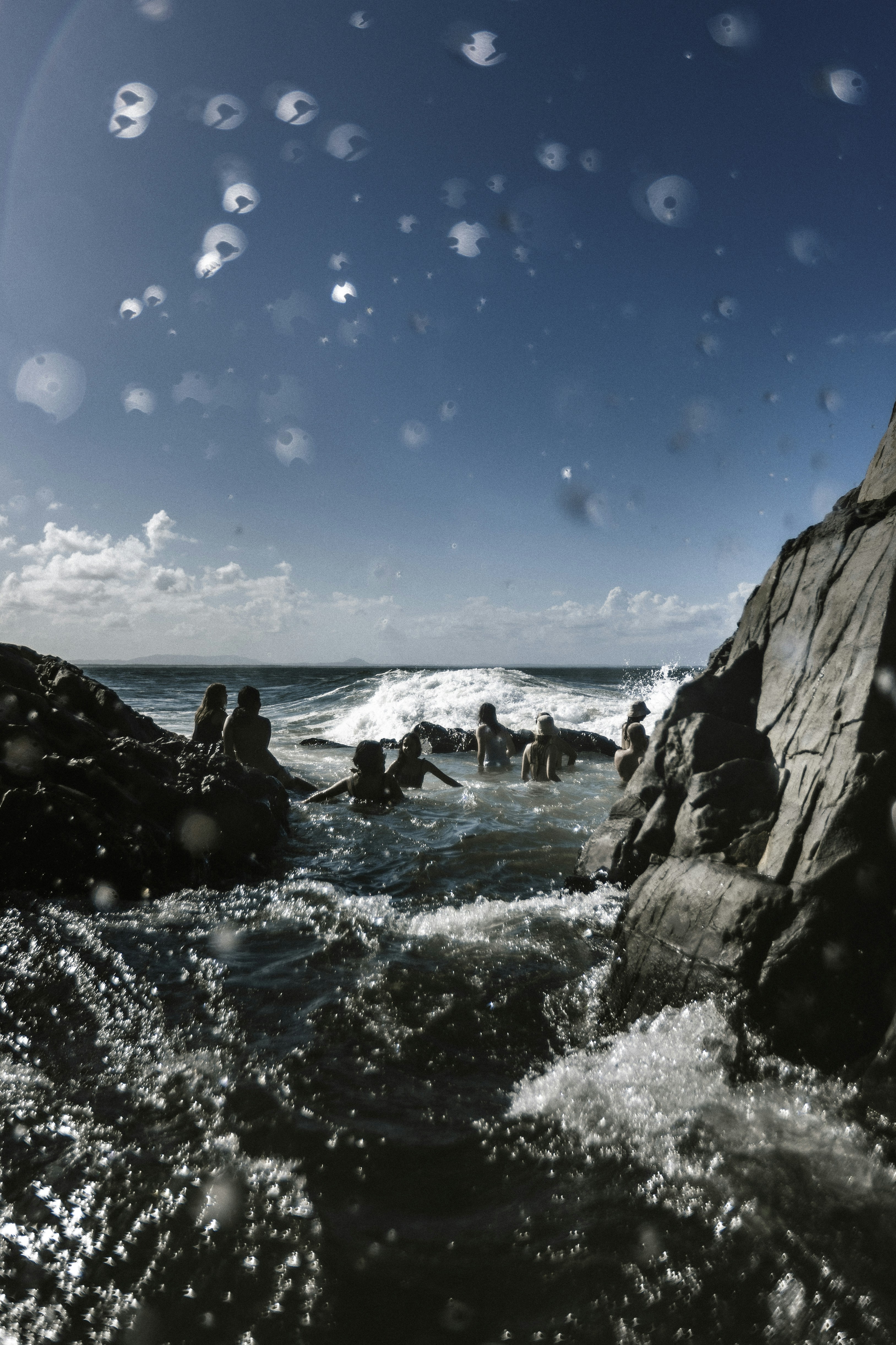 A group of people swimming in a body of water