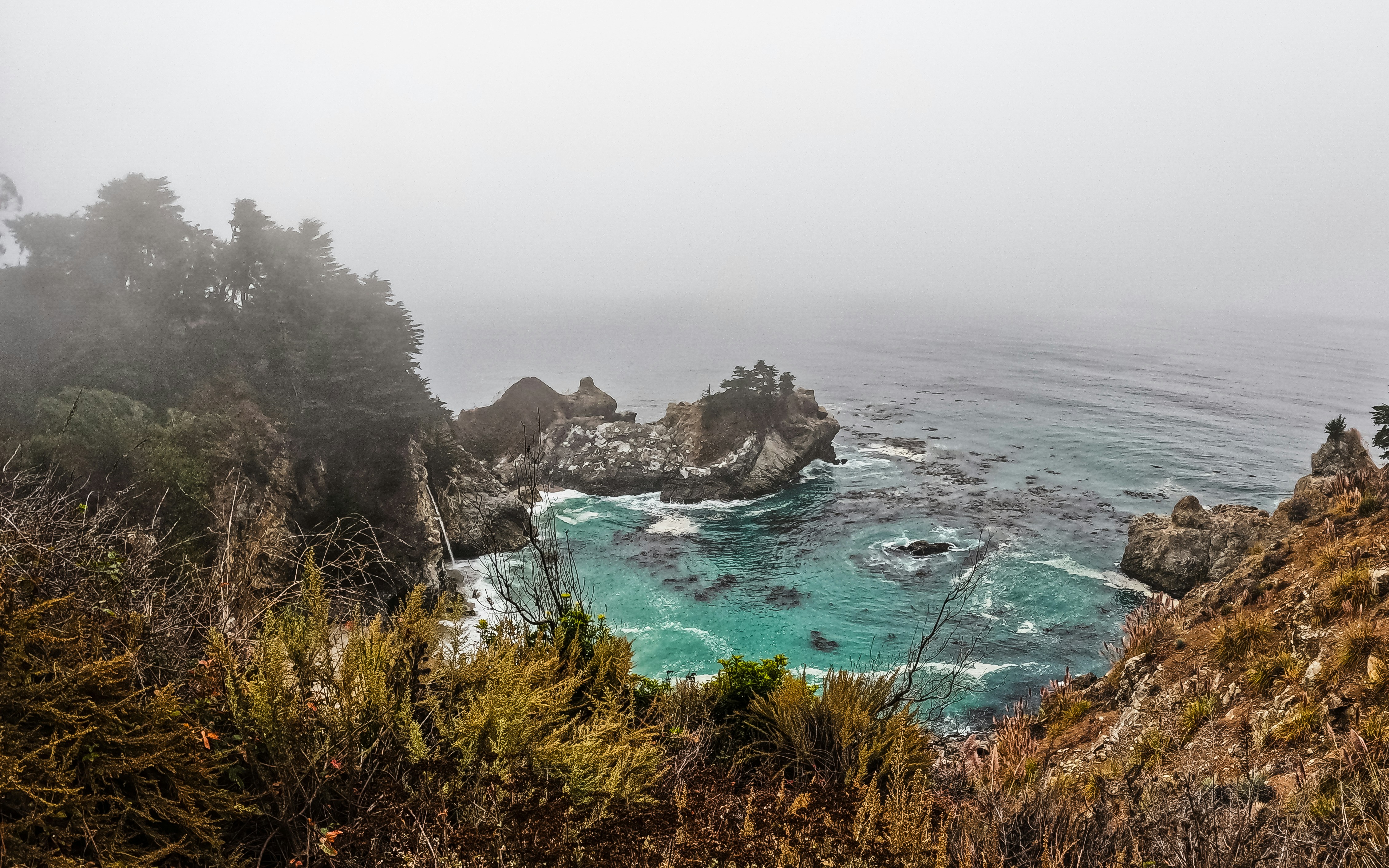 A view of a body of water from a hill, 