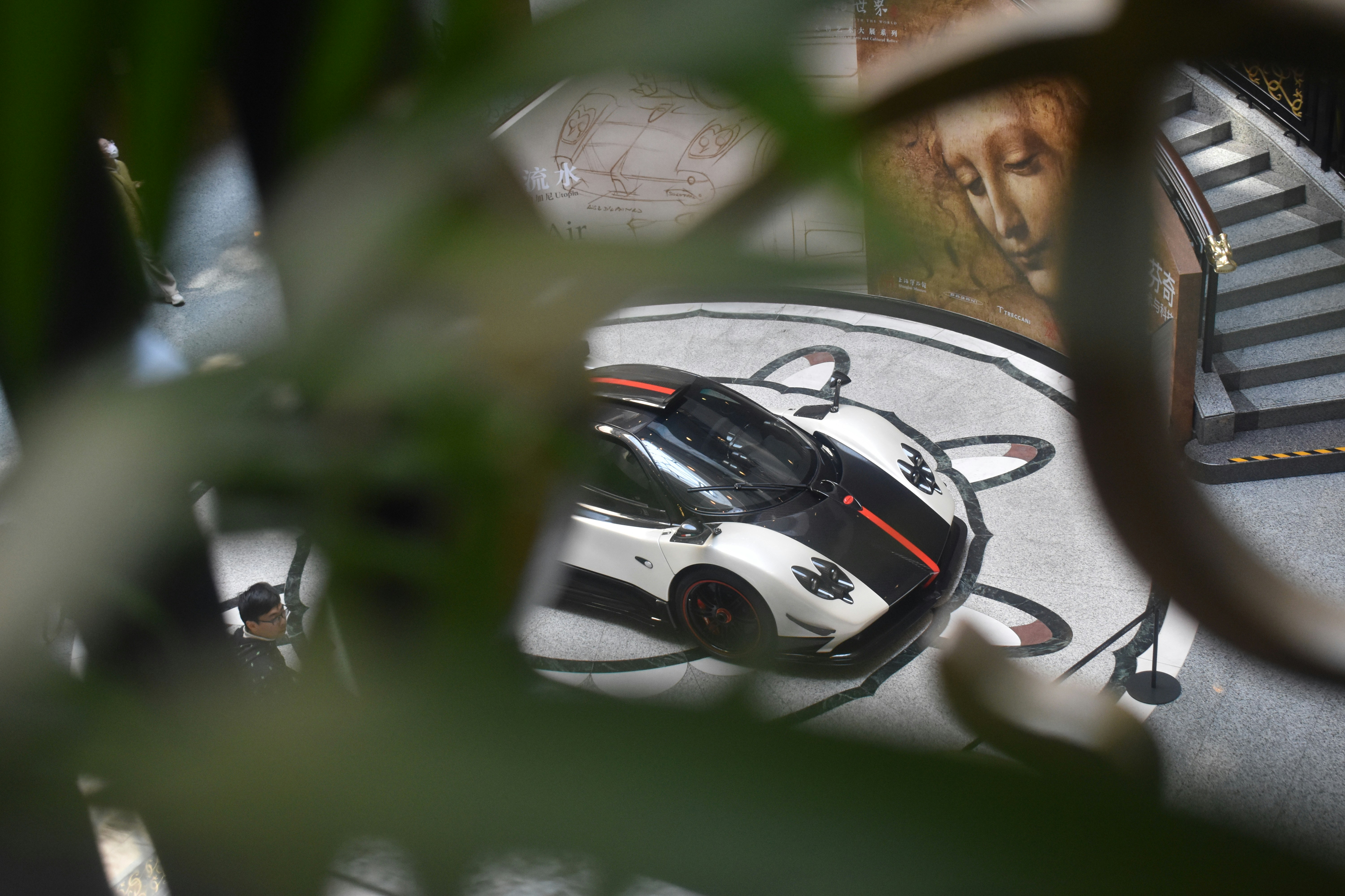 A car is seen through a mirror on a table