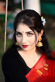 A woman wearing a red and black sari
