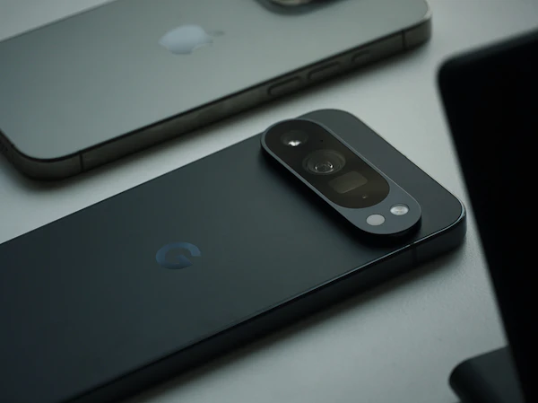 Dark smartphone lying face down showing its camera bar